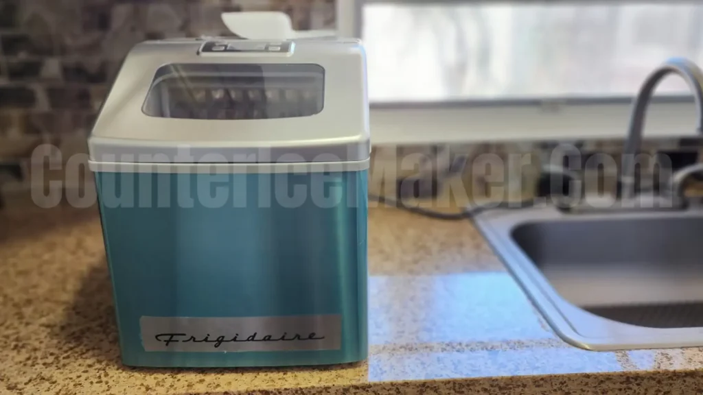 frigidaire ice maker efic452 wrapped in protective tape on a counter near the sink